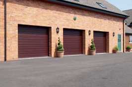 three single burgundy roller garage doors